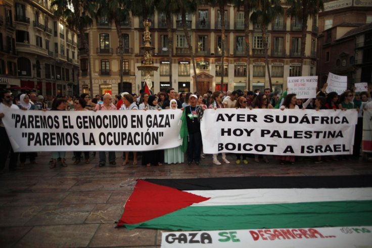 People hold banners during a protest against Israel's military action in Gaza, at La Constitución Square in Malaga(Reuters)