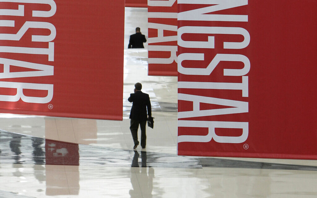 In this Thursday, June 24, 2010, file photo, attendees of a Morningstar investment conference walk beneath banners at the McCormick Center in Chicago. (AP Photo/M. Spencer Green, File)